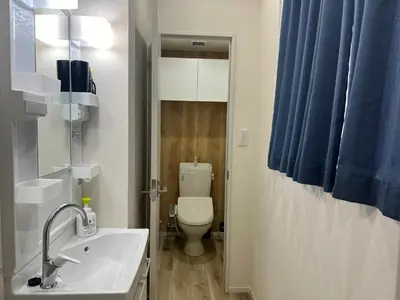 a bathroom with a white sink and a toilet at Ikebukuro Area 41 NishiikeApartment in Tokyo