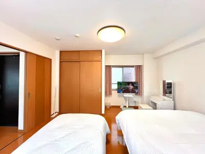 a hotel room with two beds and a tv at Nishiwaseda 501-SJ0185 in Tokyo
