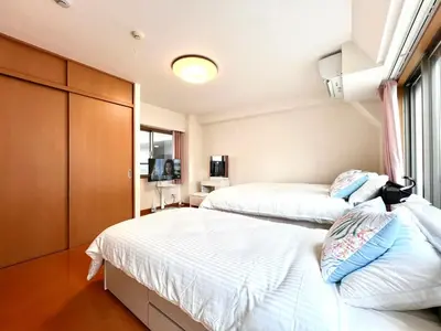 a bedroom with two beds and a tv in it at Nishiwaseda 501-SJ0185 in Tokyo