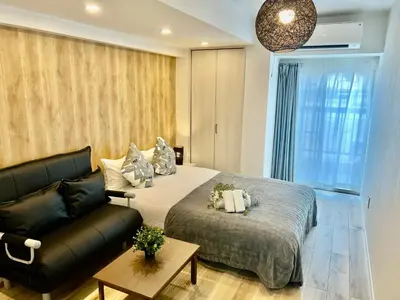 a bedroom with a bed and a couch at Ikebukuro Area 45 NishiikeApartment in Tokyo