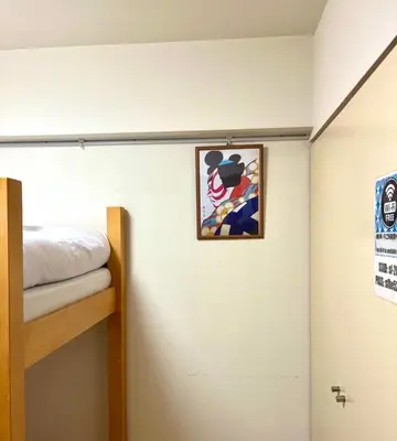 a room with a bunk bed and a picture on the wall at SF Heigths in Tokyo