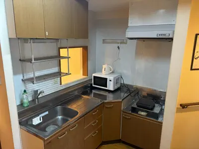 a small kitchen with a sink and a microwave at SF Heigths in Tokyo