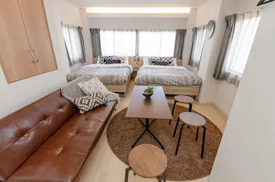 a living room with a couch and a table at ASAHI-Entire building reserved in Tokyo