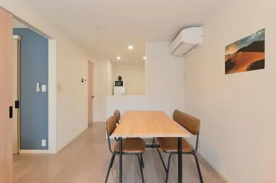 a dining room with a wooden table and chairs at Victoria \u4e0b\u5317\u6ca2 by Tranova in Tokyo