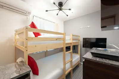 a bedroom with a bunk bed in a room at LaVie\u56db\u8c37 in Tokyo