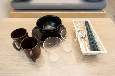 a table with four cups and a tray with glasses at LaVie\u56db\u8c37 in Tokyo