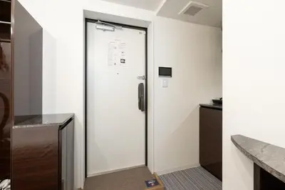 a door in a room with a kitchen at LaVie\u56db\u8c37 in Tokyo