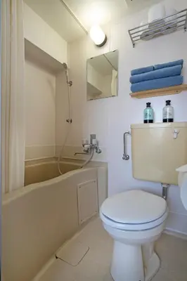 a bathroom with a toilet and a tub and a sink at CraftFlat Komagome 604, compact studio at excellent location in Tokyo