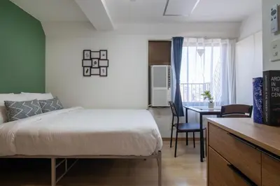 a bedroom with a bed and a dining room at CraftFlat Komagome 604, compact studio at excellent location in Tokyo