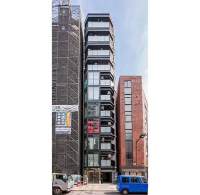 a rendering of a tall building with cars parked in front at 67 Apt Kinshicho in Tokyo