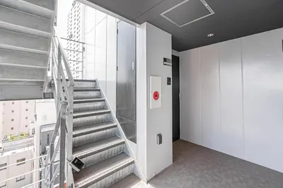 a spiral staircase in a building with a window at 67 Apt Kinshicho in Tokyo