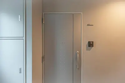 a glass door in a room next to a wall at M S I Kagurazaka in Tokyo