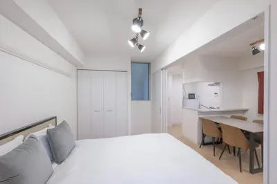 a bedroom with a white bed and a table at M S I Kagurazaka in Tokyo