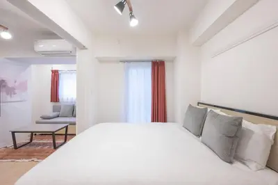 a bedroom with a large white bed and a couch at M S I Kagurazaka in Tokyo