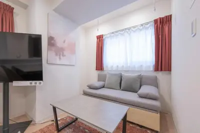 a living room with a couch and a tv at M S I Kagurazaka in Tokyo