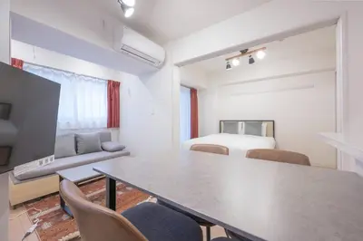 a room with a table and chairs and a bed at M S I Kagurazaka in Tokyo