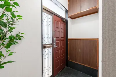 a red door in a building with a door at \u65b0\u5927\u585a\u6238\u5efa\u3066 in Tokyo