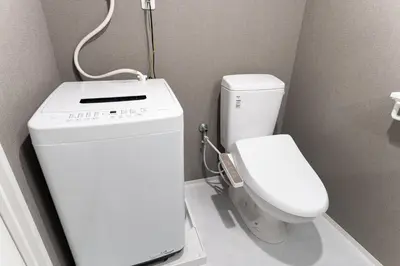 a small bathroom with a toilet and a sink at Omotenashi HOTEL Asakusa in Tokyo