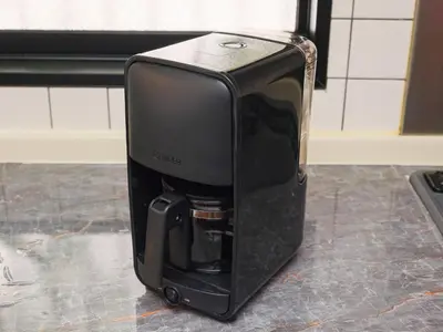 a black coffee maker sitting on a counter at Comfort HASUNUMA in Tokyo