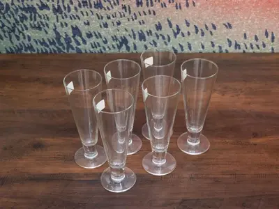 a group of clear glasses sitting on a wooden table at Comfort HASUNUMA in Tokyo