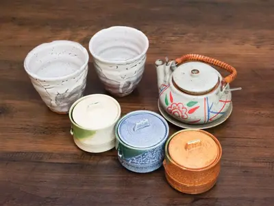 a group of bowls and cups sitting on a table at Comfort HASUNUMA in Tokyo