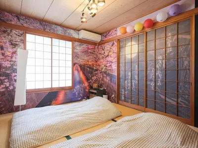 a bedroom with a colorful mural on the wall at Comfort HASUNUMA in Tokyo