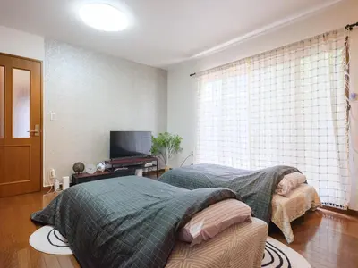 a bedroom with a bed and a television in it at Comfort HASUNUMA in Tokyo