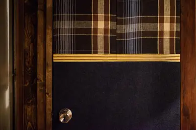 a wooden door with a plaid curtain on it at Bamba Hotel Tokyo-Private Townhouse- in Tokyo