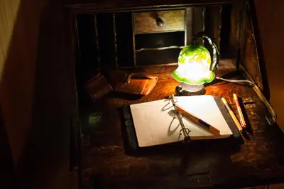 a desk with a lamp and a notebook and a pencil at Bamba Hotel Tokyo-Private Townhouse- in Tokyo