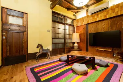 a living room with a tv and a horse statue at Bamba Hotel Tokyo-Private Townhouse- in Tokyo