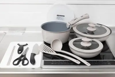 a stove top with two pots and pans on it at Takakou building in Tokyo