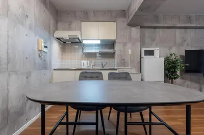 a kitchen with a table and chairs in a room at Takakou building in Tokyo