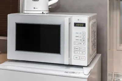 a microwave oven sitting on top of a counter at Takakou building in Tokyo