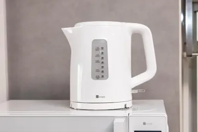 a white blender sitting on top of a refrigerator at Takakou building in Tokyo