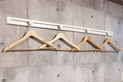 a group of hangers hanging on a wall at Takakou building in Tokyo