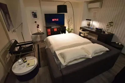 a bedroom with a bed and a tv in it at LANG - Vacation STAY 22203v in Tokyo