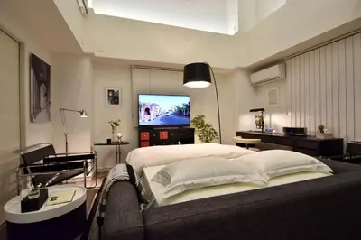 a bedroom with a bed and a television in it at LANG - Vacation STAY 22203v in Tokyo