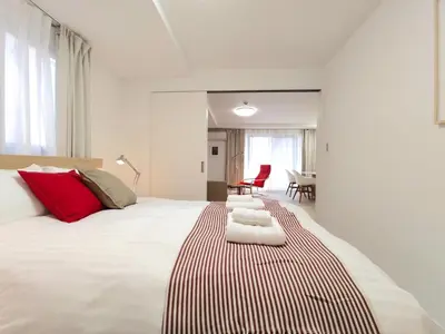 a bedroom with a large white bed with red pillows at LANG - Vacation STAY 22184v in Tokyo