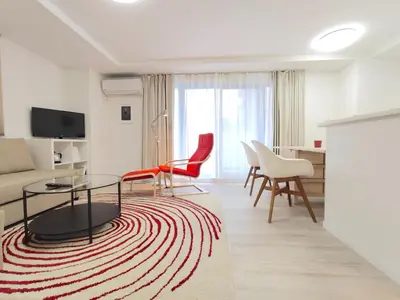 a living room with a couch and a table and chairs at LANG - Vacation STAY 22184v in Tokyo