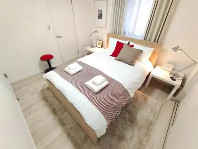 a bedroom with a large bed with two pillows on it at LANG - Vacation STAY 22184v in Tokyo