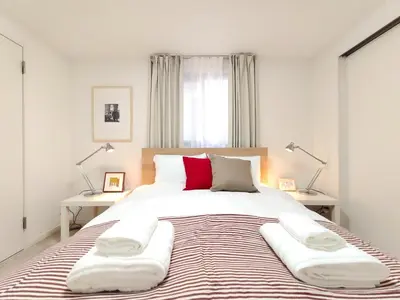 a bedroom with a large bed with two lamps at LANG - Vacation STAY 22184v in Tokyo