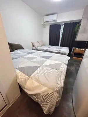 a room with two beds and a couch in it at Hotel \u7c8bSUI Shinjuku in Tokyo