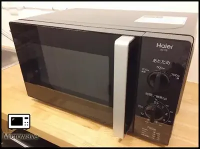 a microwave oven sitting on top of a table at Hotel \u7c8bSUI Shinjuku in Tokyo
