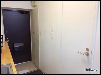 a bathroom with a door to a hallway with a sink at Hotel \u7c8bSUI Shinjuku in Tokyo
