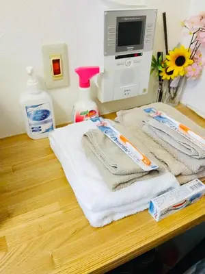 a table with two towels and a computer monitor at Hotel \u7c8bSUI Shinjuku in Tokyo