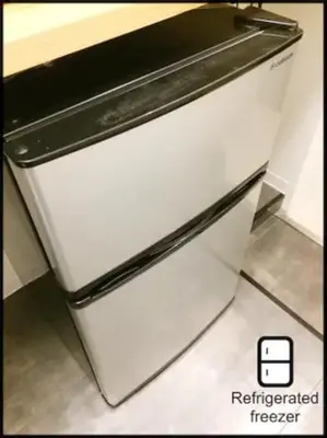 a white refrigerator freezer sitting in a kitchen at Hotel \u7c8bSUI Shinjuku in Tokyo