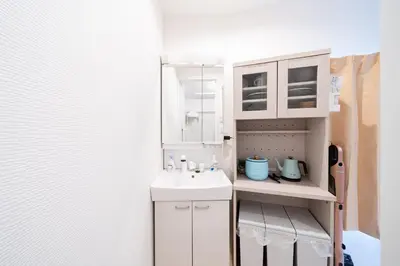 a small bathroom with a sink and a white cabinet at Direct access to major Tokyo stations including Shibuya, Shinjuku, Ikebukuro, Akihabara, and Ueno 3-minute walk from nearest station Tokyo Dome Suitable for long-term stays 201 in Tokyo