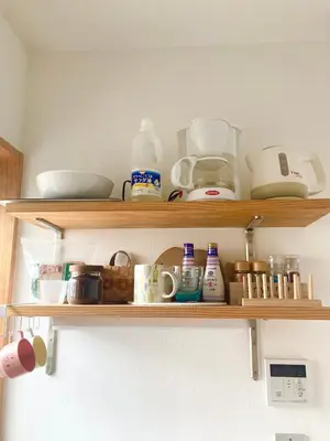 a shelf with dishes and other kitchen items on it at Asukayama Forrest in Tokyo