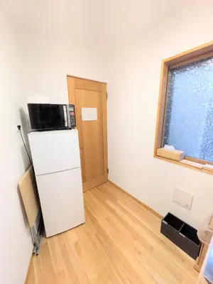 a small room with a refrigerator and a window at Asukayama Forrest in Tokyo