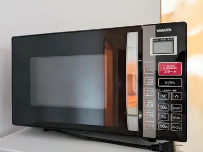 a microwave oven sitting on top of a table at Asukayama Forrest in Tokyo